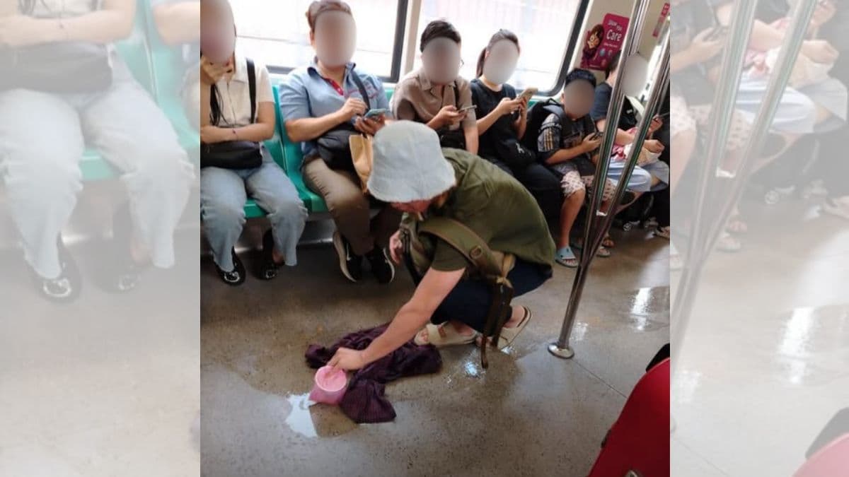 man wipes spilt drink on mrt (1).jpg